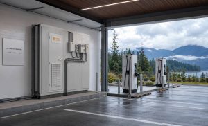 KRL B2M6L energy storage container inside a purpose-built Vancouver EV charging energy centre with British Columbia mountains and evergreen landscape visible beyond the site