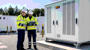 Engineers reviewing a commercial BESS decommissioning plan beside a KRL-branded battery storage cabinet