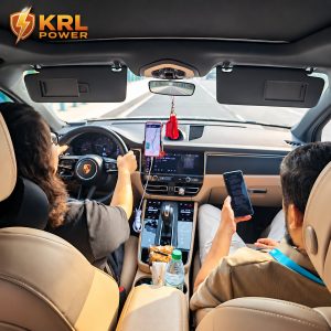 KRL Power representative accompanies Bangladesh EPC visitors by car for the factory visit, with KRL Power logo at upper left and rear-view mirror cleared